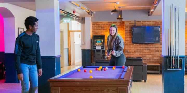Students playing pool in the LMH Bar