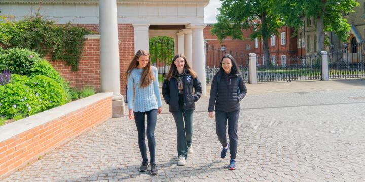 Students walking outside the front gate at LMH